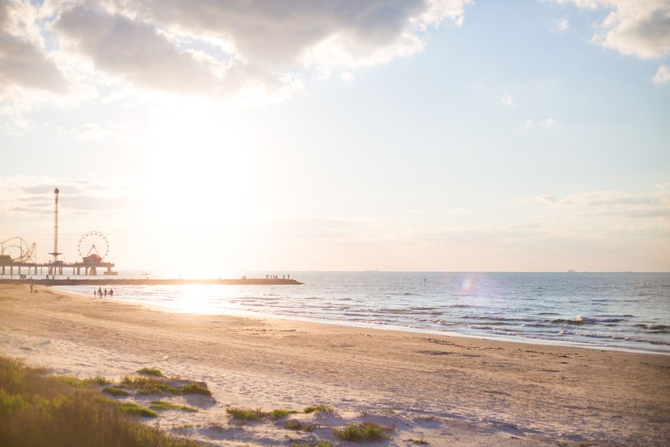 Golden light on Galveston beach with the Pleasure Pier in the distance