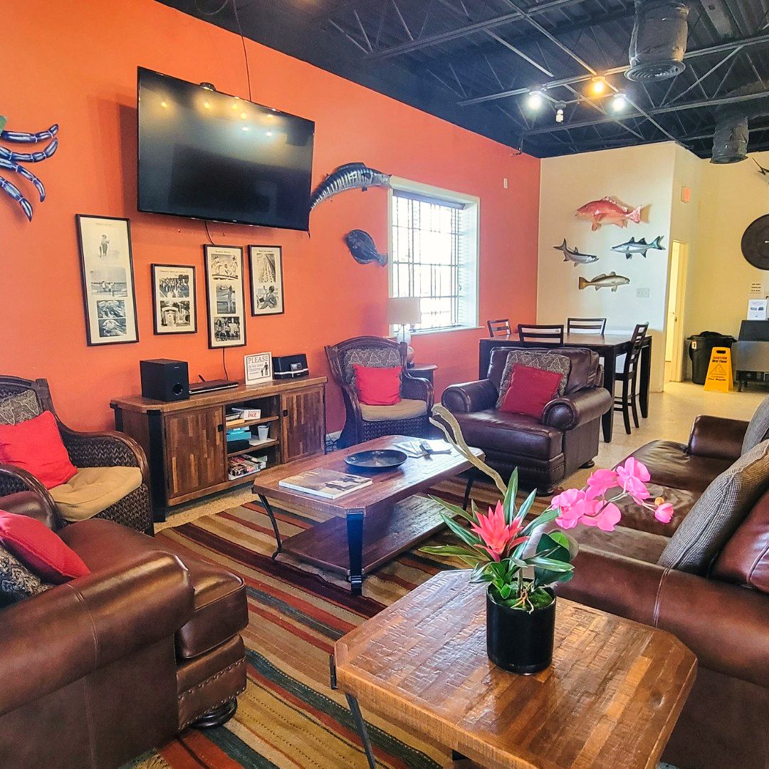 Leather armchairs and the TV wall in the clubhouse lounge