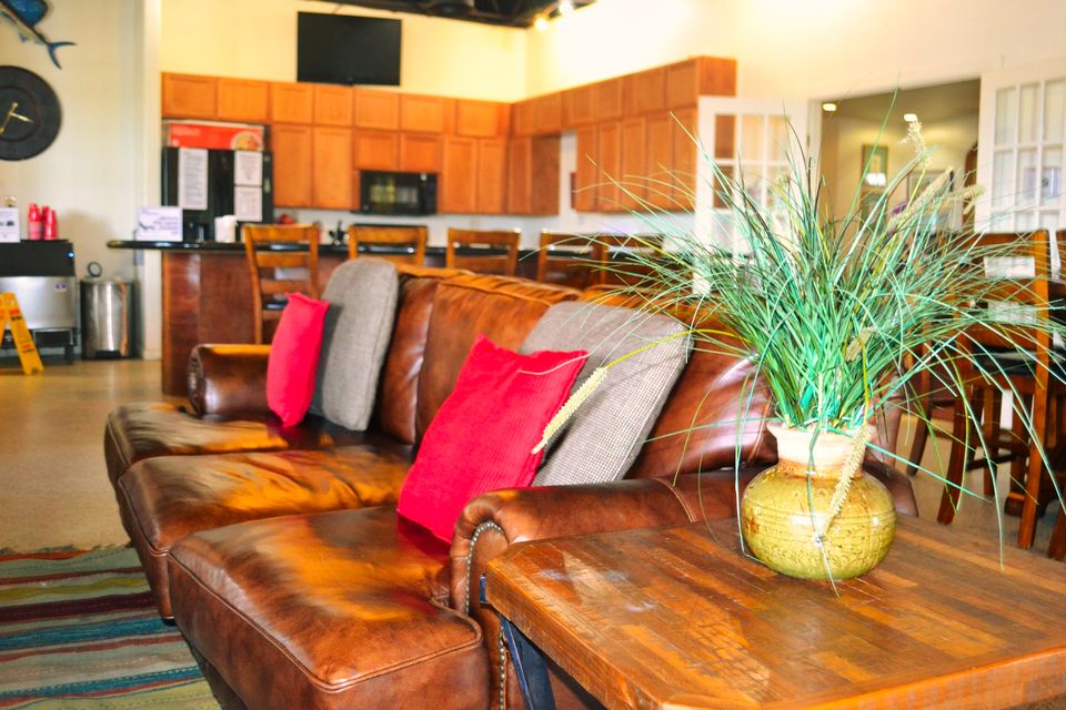 Leather sofa and kitchen in the Sandpiper clubhouse lounge