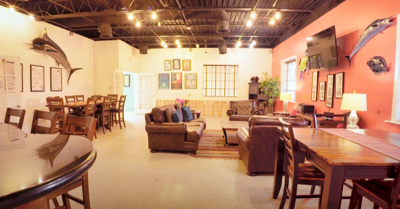 The clubhouse social room with sofas and a mounted TV