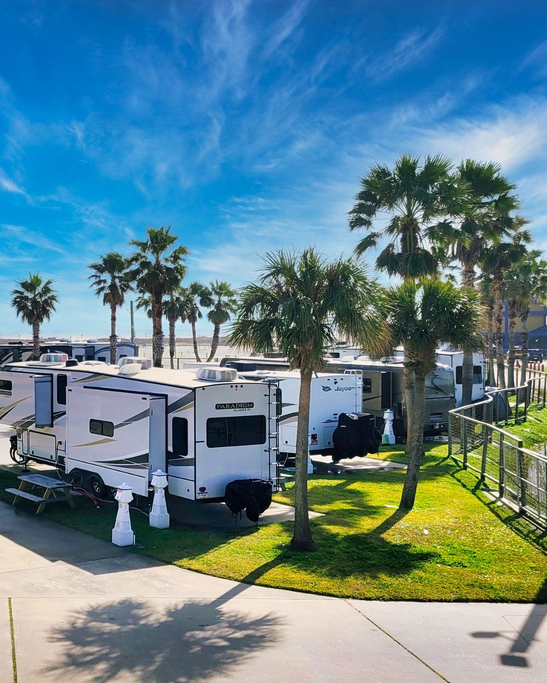 An RV on a concrete pad at Sandpiper RV Resort