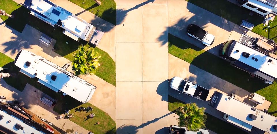 Wide view of the RV sites and palms at Sandpiper RV Resort